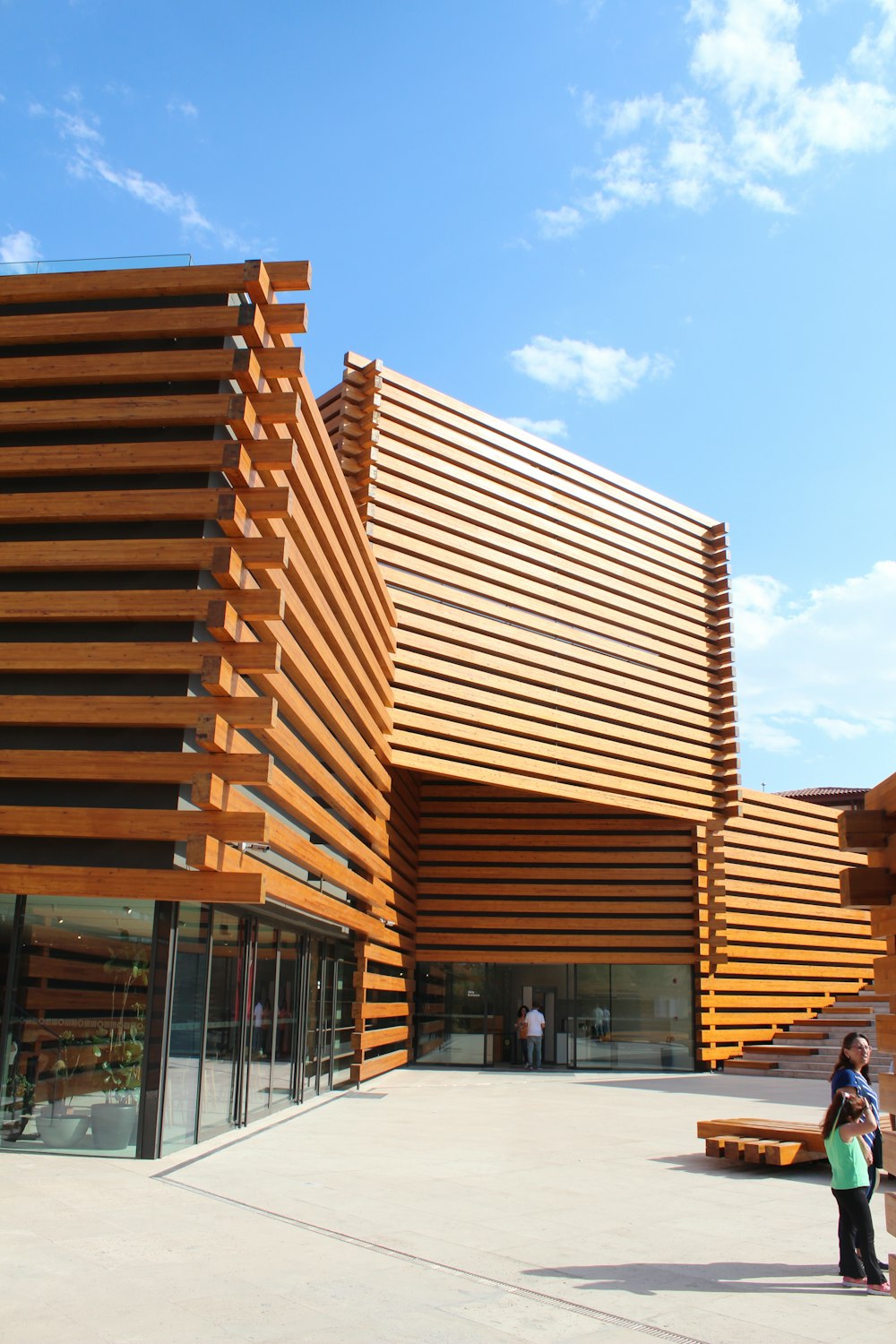 a woman standing in front of a large building