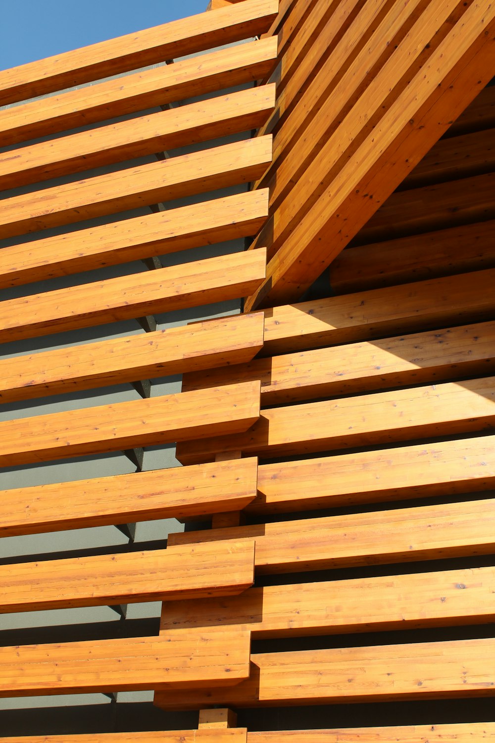 a close up of a wooden structure against a blue sky