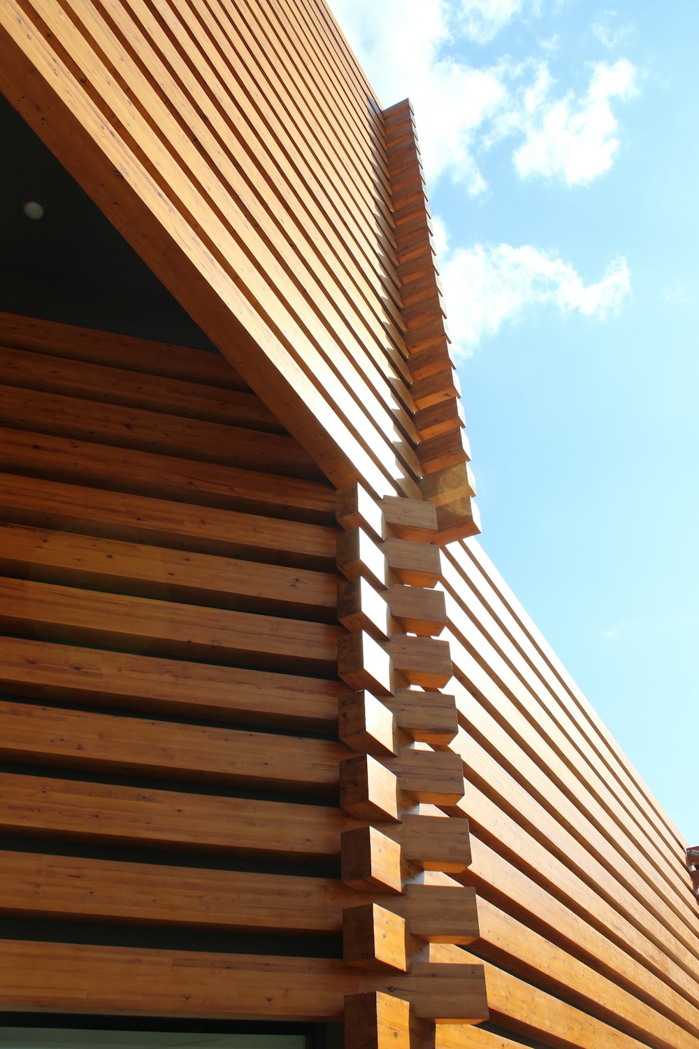a close up of a wooden building with a sky background