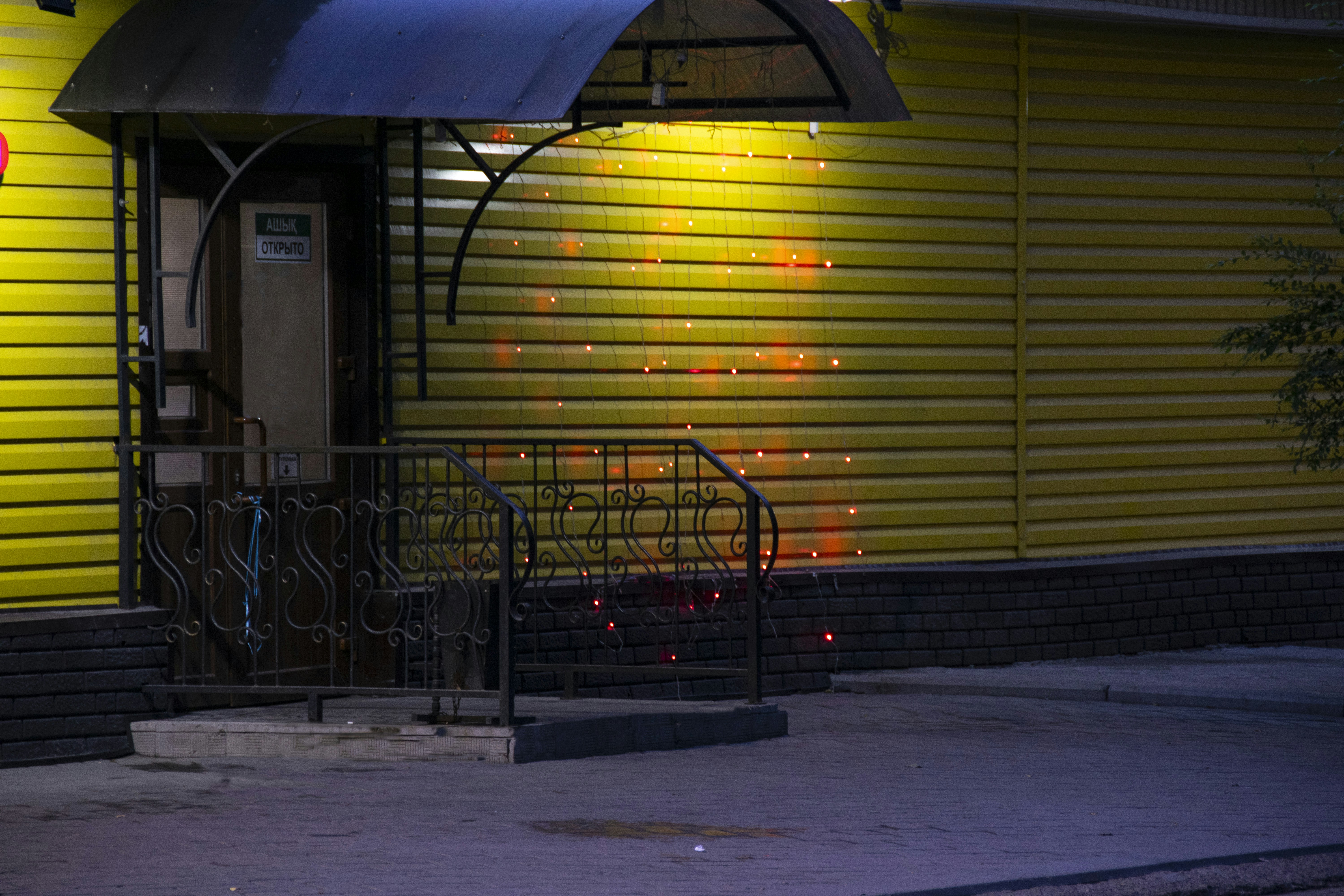 a yellow building with a blue awning over it