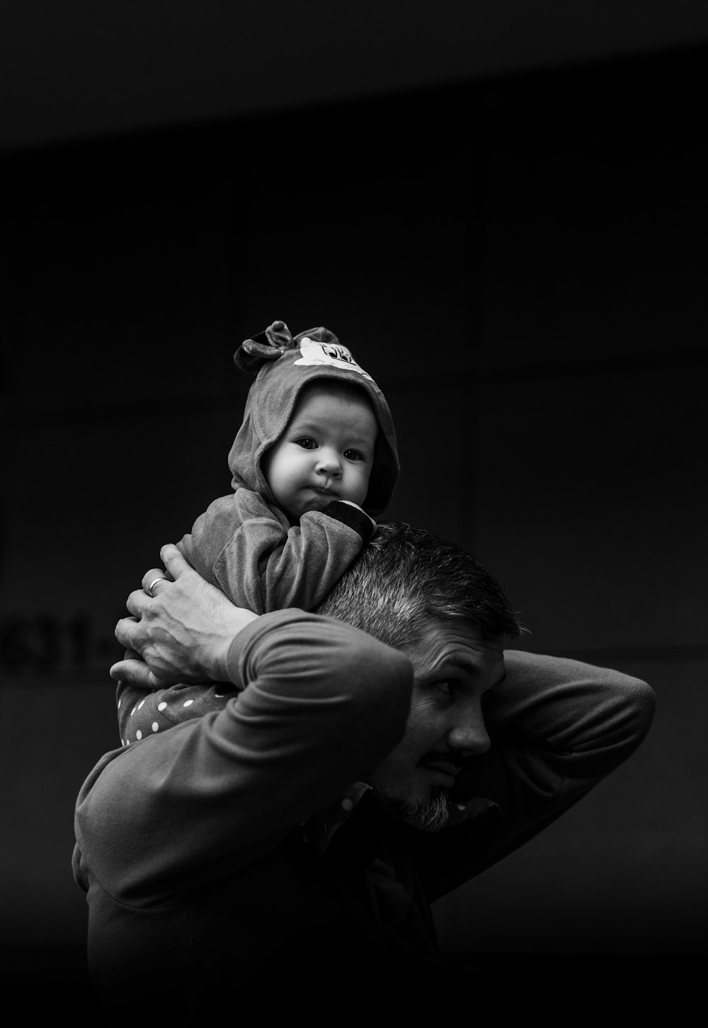a black and white photo of a man holding a child