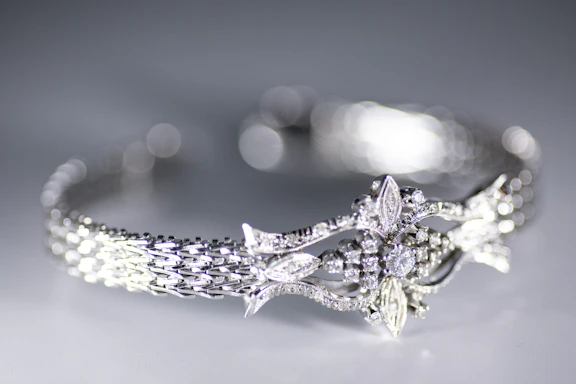 A close-up of intricate diamond grillz set against a soft, elegant background.