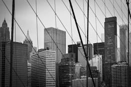 An engineer analyzing structural data on a tablet with a city skyline in the background.