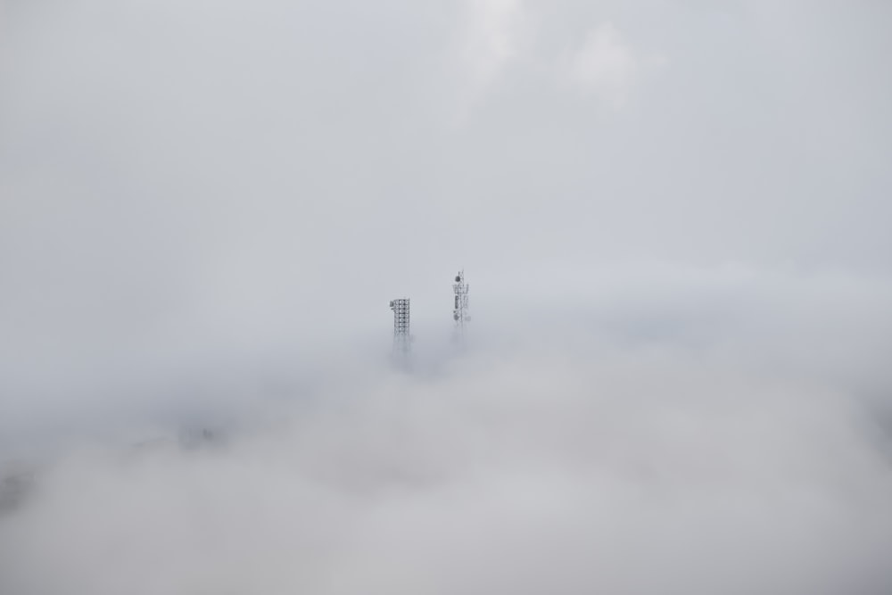 a very tall building in the middle of a foggy sky