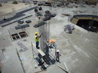 a group of men standing on top of a construction site