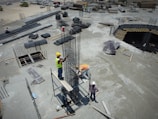 a group of men standing on top of a construction site