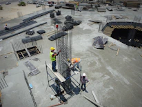 a group of men standing on top of a construction site
