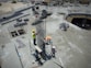 a group of men standing on top of a construction site