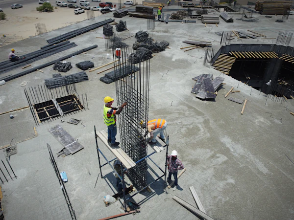 Construction workers in safety gear discussing work on site