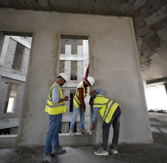 a group of men standing next to each other in front of a building