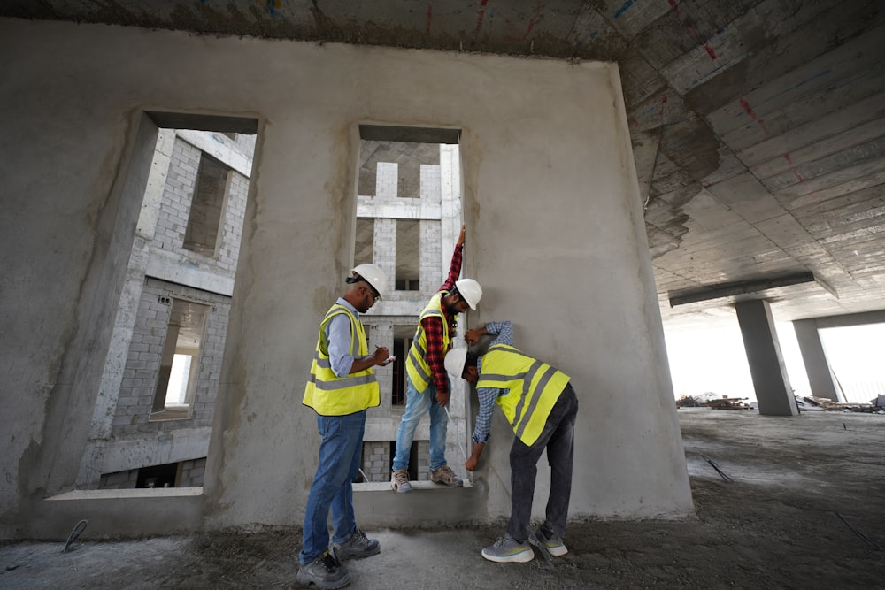 a group of men standing next to each other in front of a building