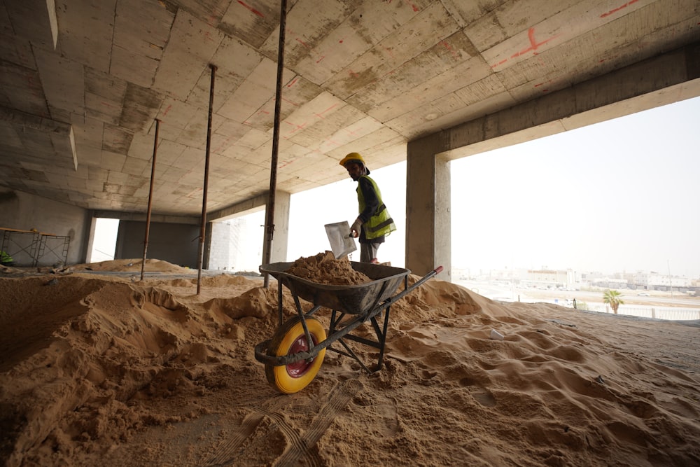 a construction worker standing in a pile of sand