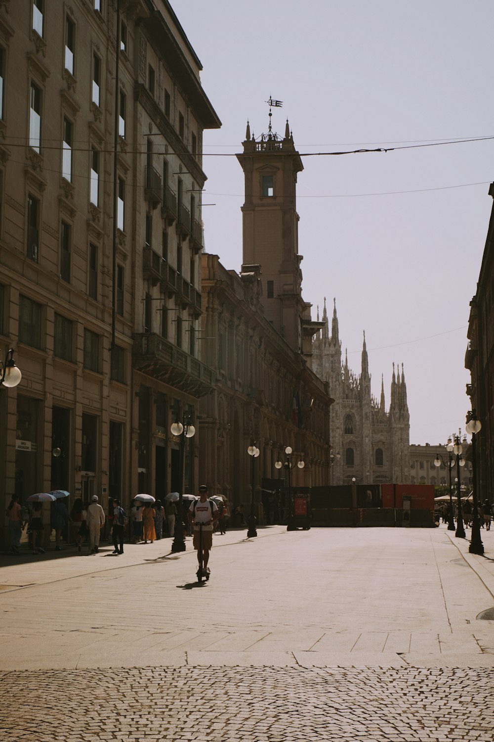 a city street with a clock tower in the background