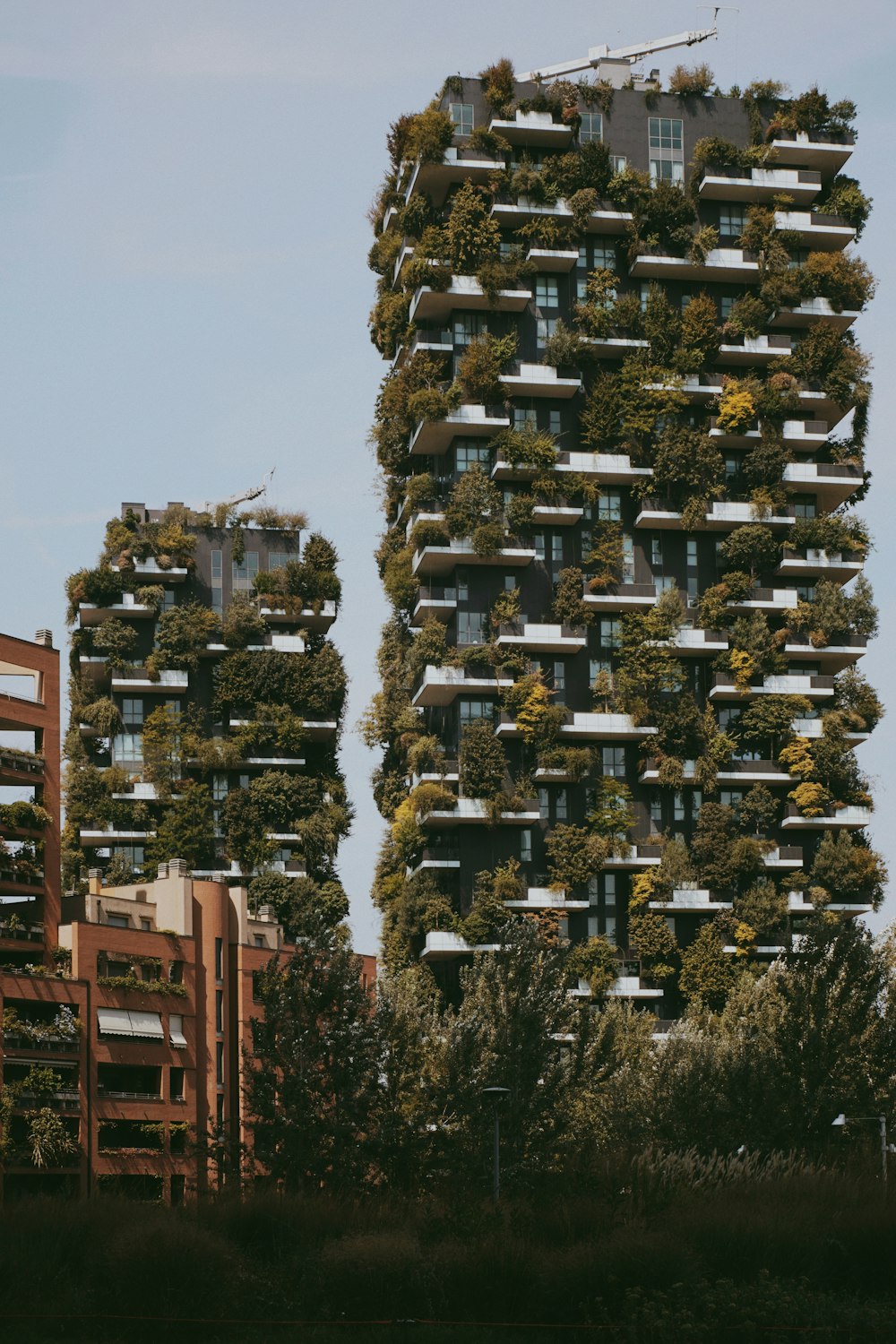 a very tall building with a lot of plants growing on it