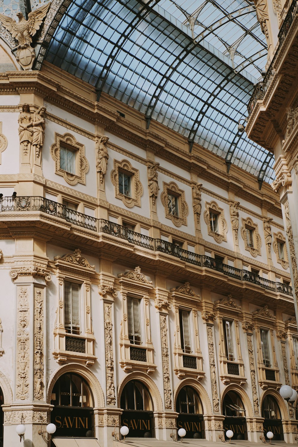 a large building with a glass roof and a clock