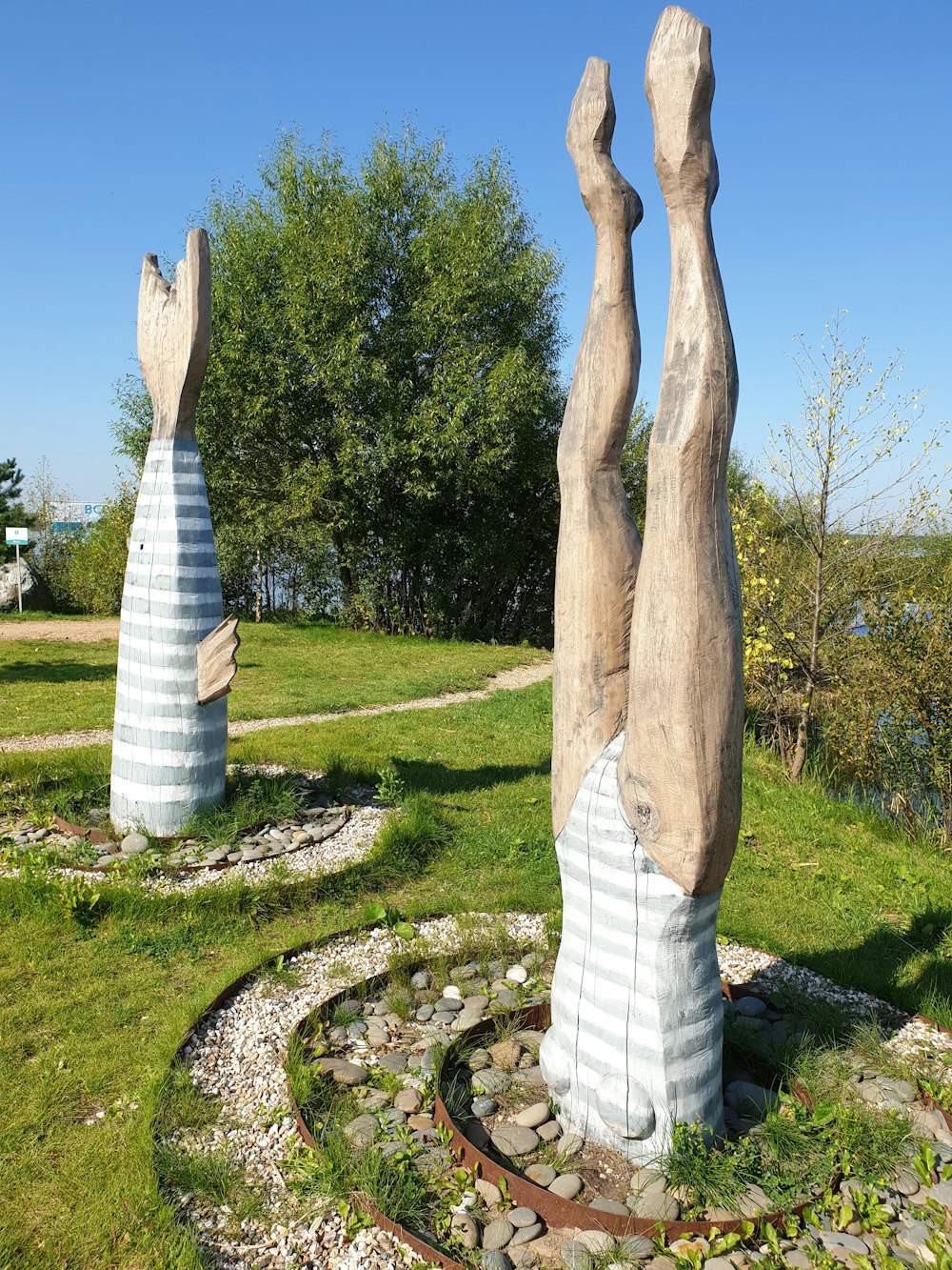 a couple of large sculptures sitting on top of a lush green field