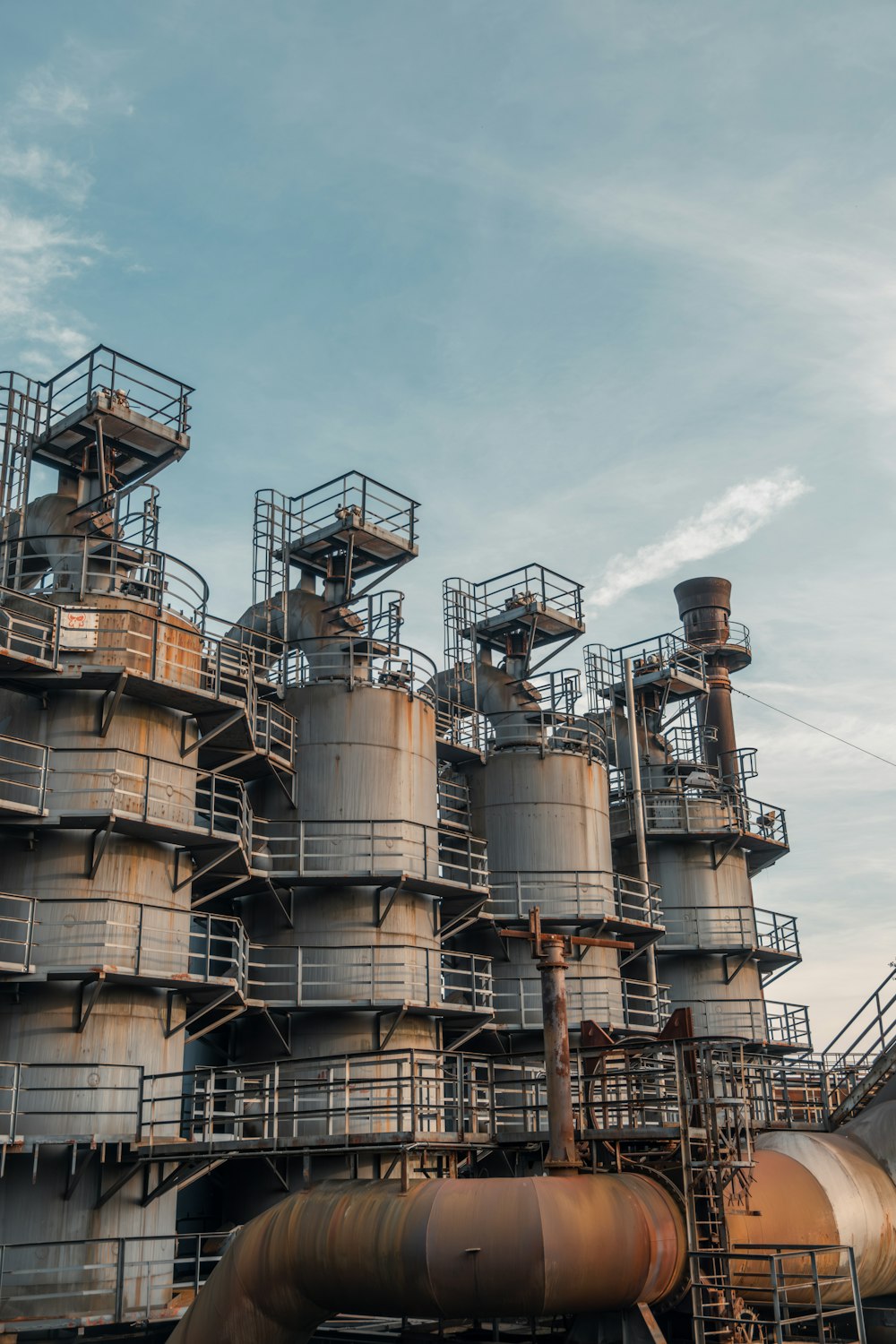 a very large industrial building with many pipes