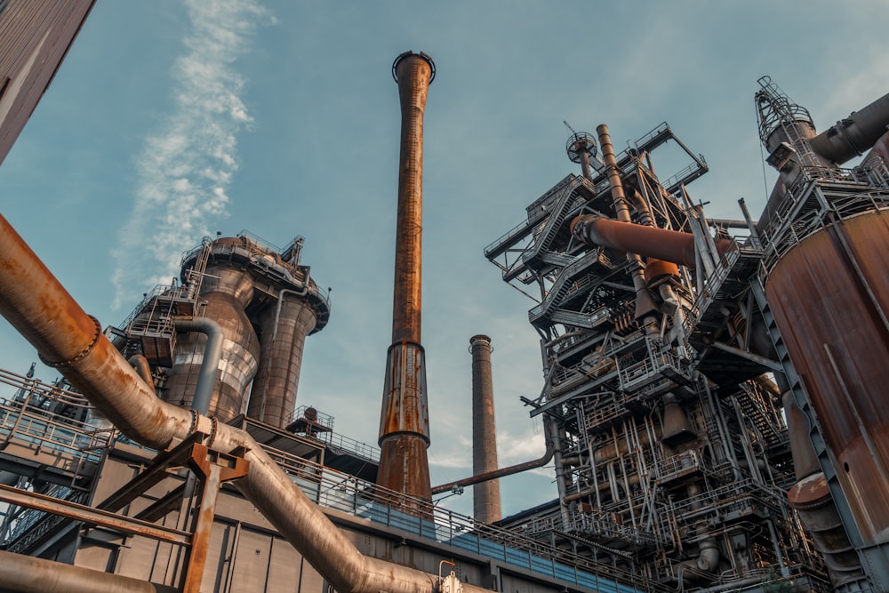 a factory with pipes and a sky background