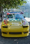 An outdoor scene featuring a car adorned with vibrant decals.
