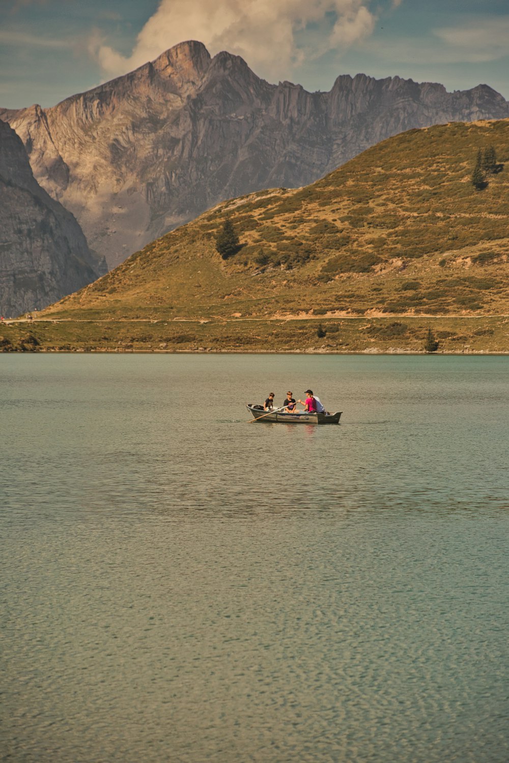 a group of people in a small boat on a lake
