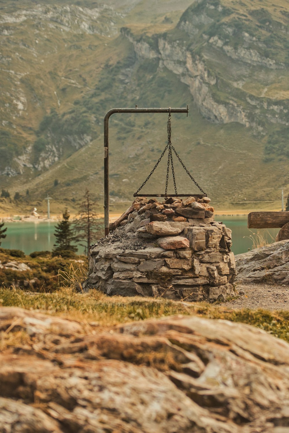 a stone structure sitting on top of a lush green hillside