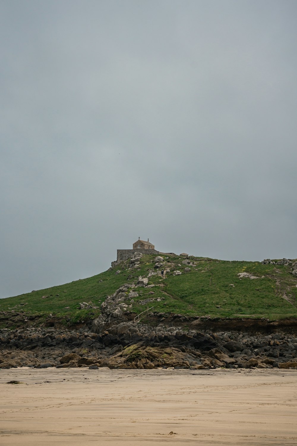 a grassy hill with a building on top of it