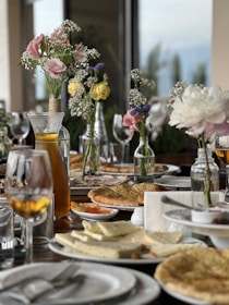 A beautifully arranged table with a variety of dishes and drinks in a restaurant setting.