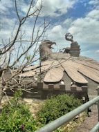 a statue of an eagle on top of a building