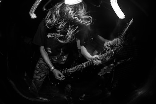 Black and white photo of Juan Baraza performing on stage, capturing intense emotion and presence.