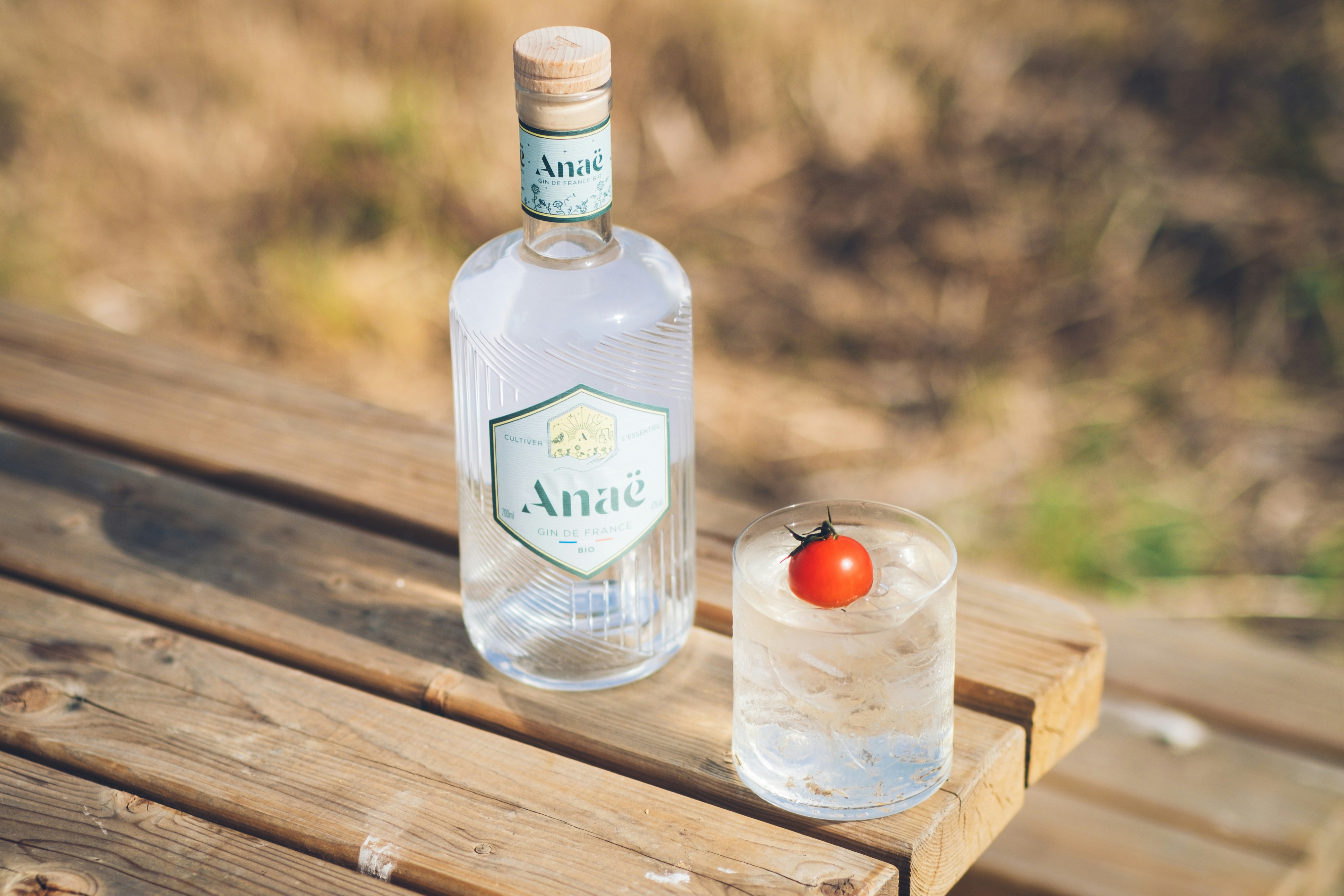 a bottle of alcohol sitting on top of a wooden table