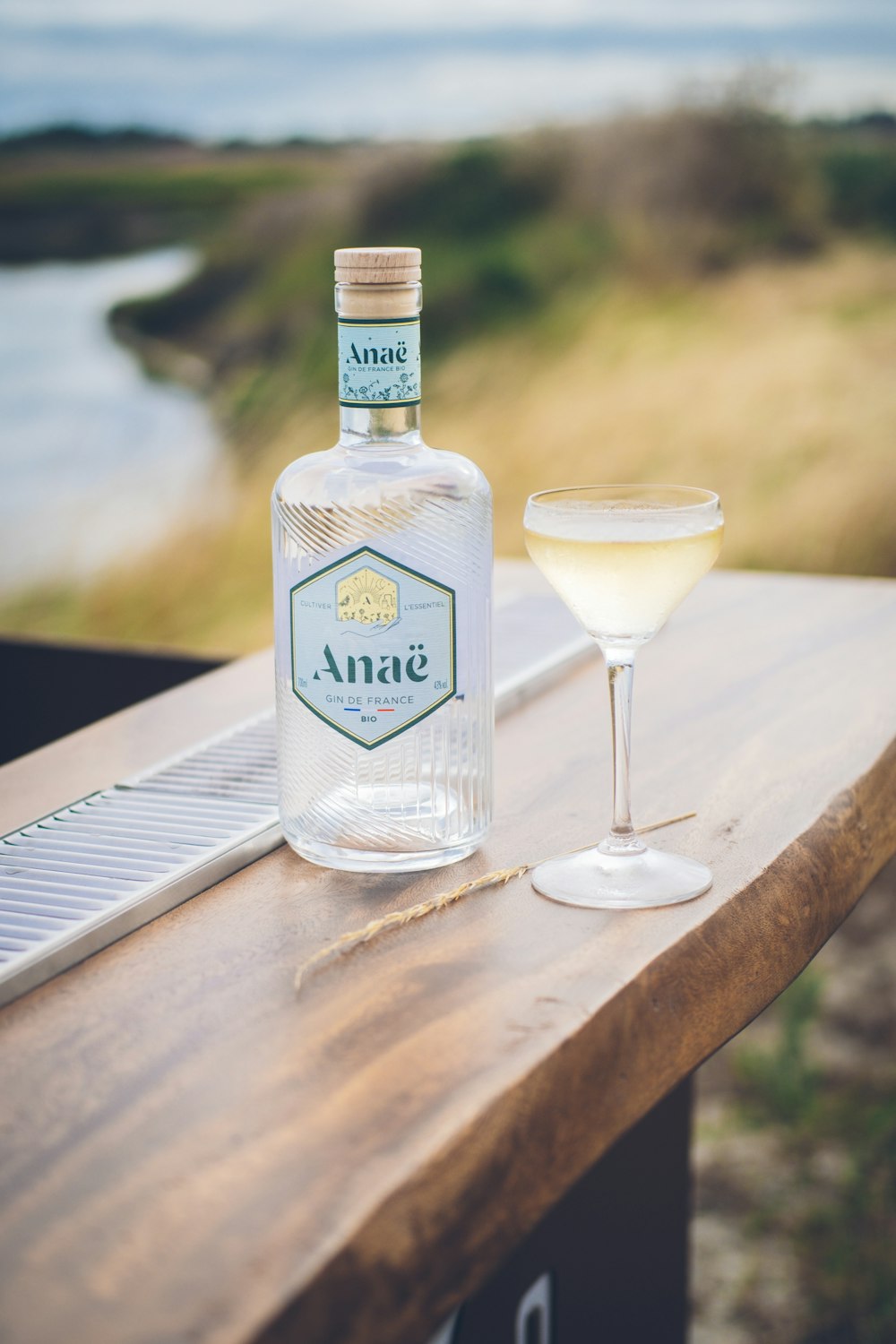 a bottle and a glass sitting on a table