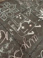 A colorful chalk drawing on a sidewalk encouraging kindness and skipping snacks.