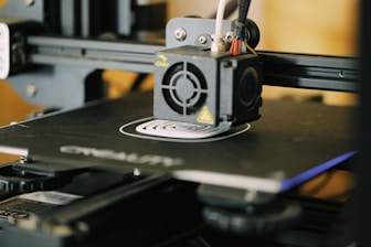 A 3D printer in action creating a detailed model.