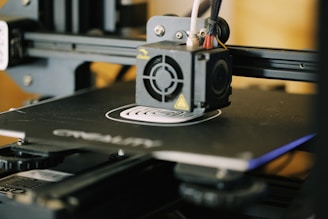 A close-up of a 3D printer in action, crafting a detailed piece for paranormal explorers.