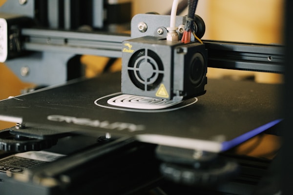 A close-up of a 3D printer in action, crafting a detailed piece for paranormal explorers.