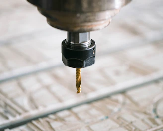 Close-up of a CNC milling machine precisely shaping a metal part in a workshop.