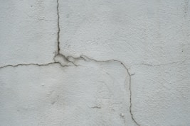 a crack in the side of a white wall
