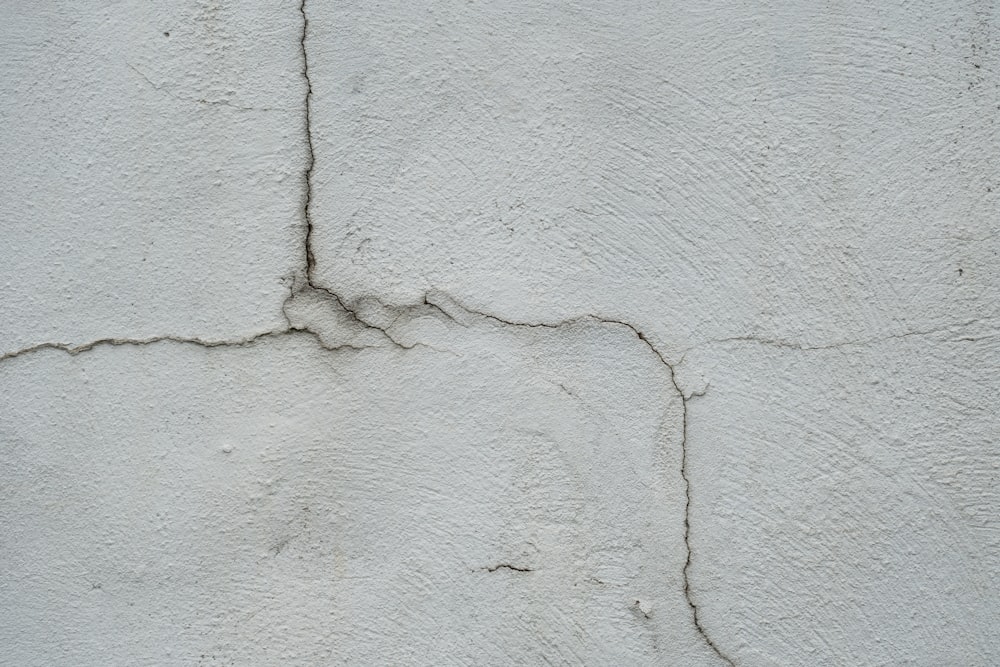 a crack in the side of a white wall