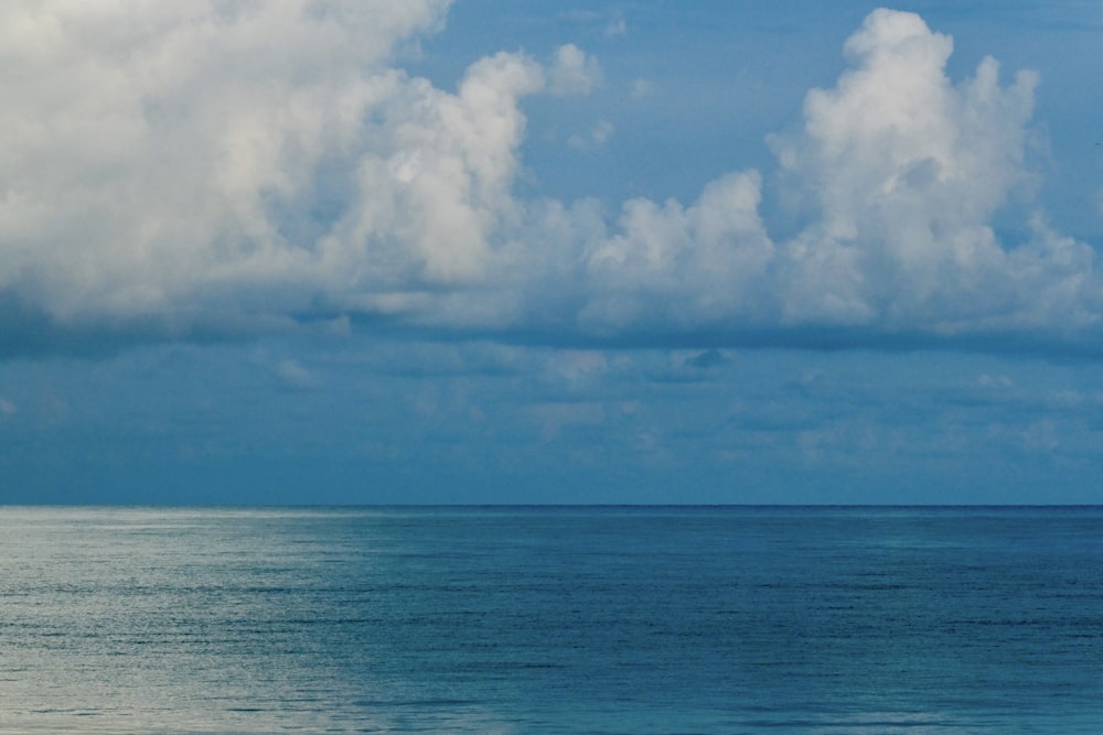 a large body of water under a cloudy sky