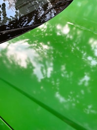 Set of microfiber cloths in vibrant colors folded on a car hood