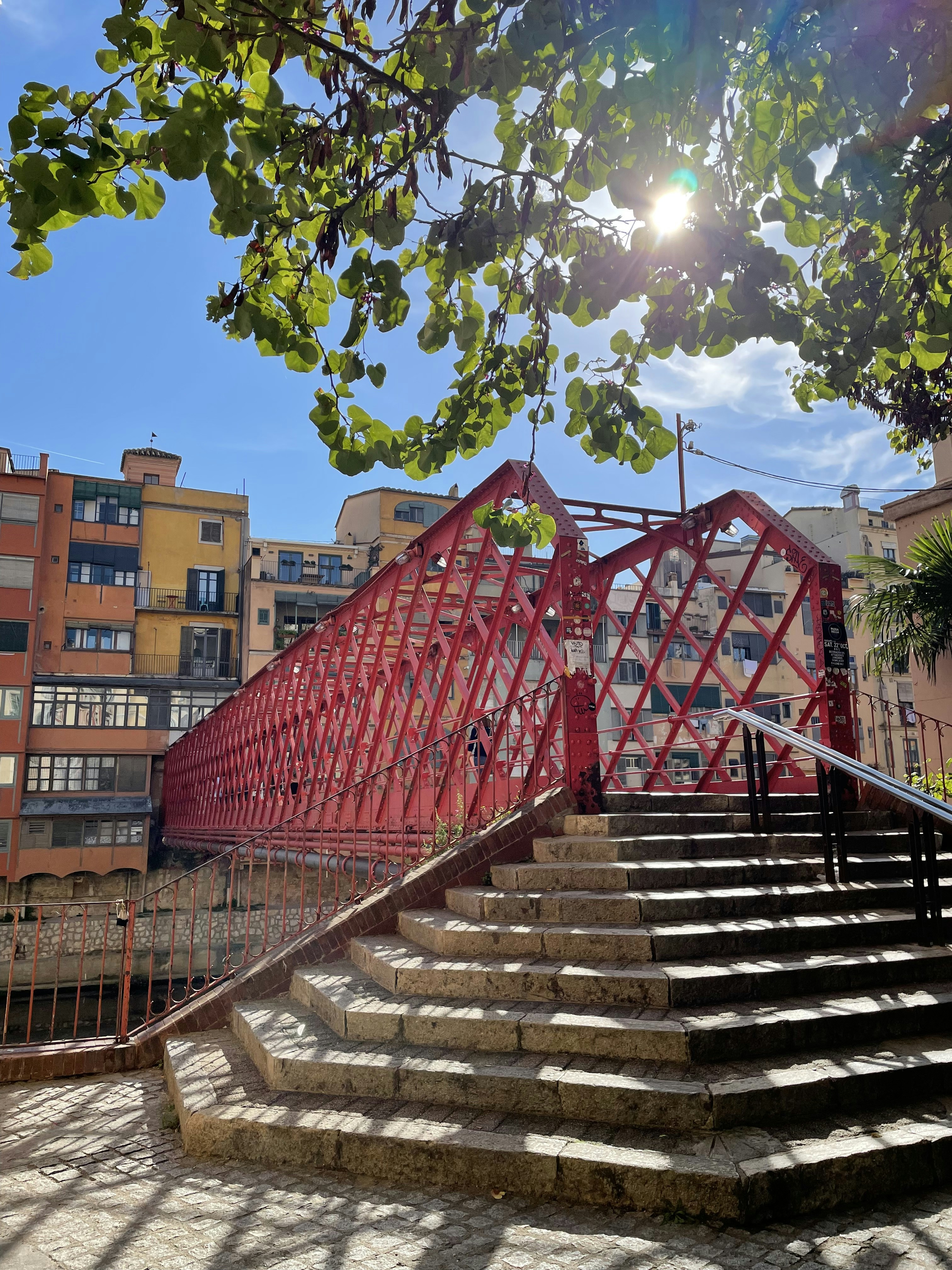 a set of stairs leading up to a red bridge eiffel bridge, Girona