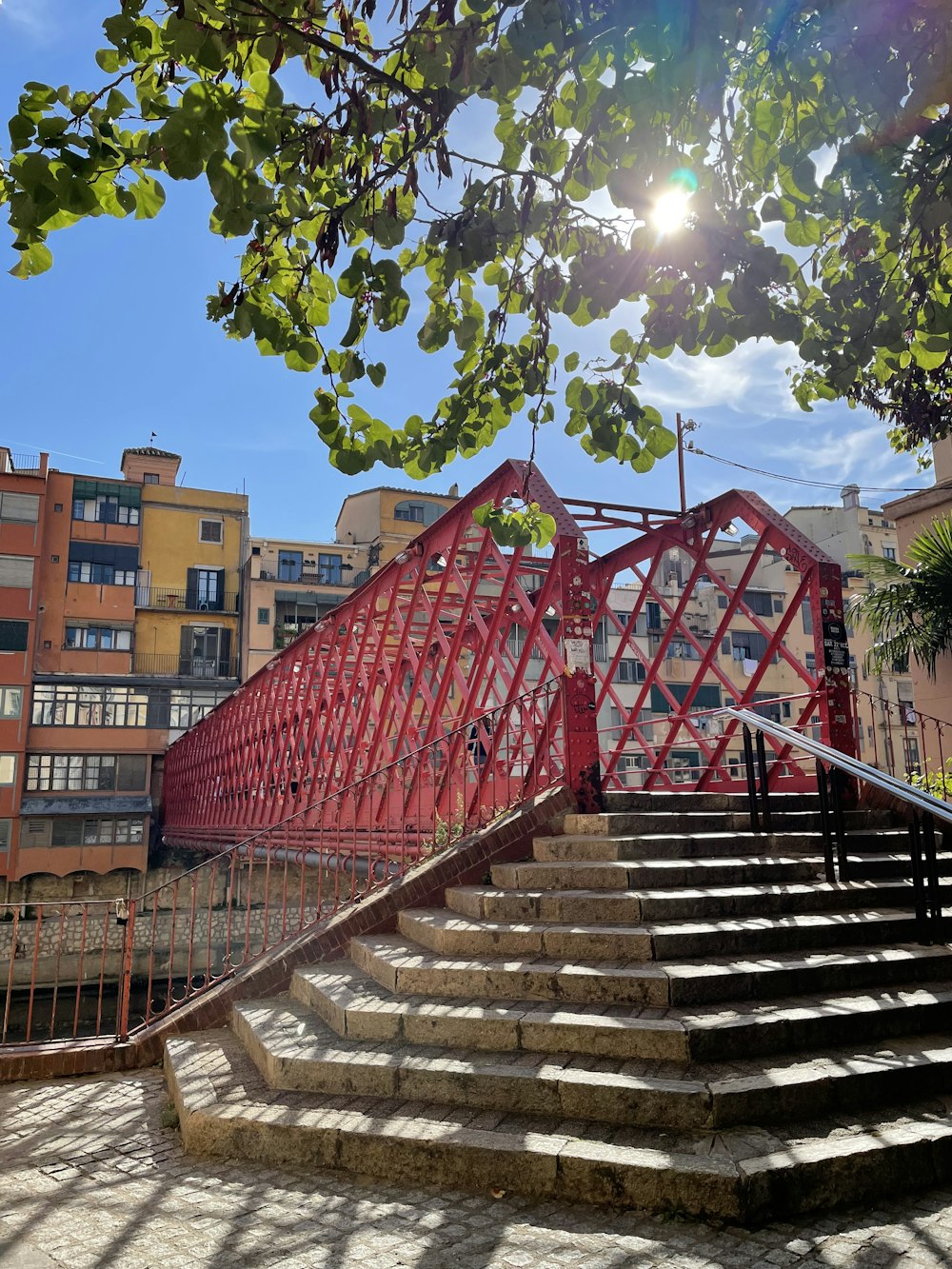 a set of stairs leading up to a red bridge