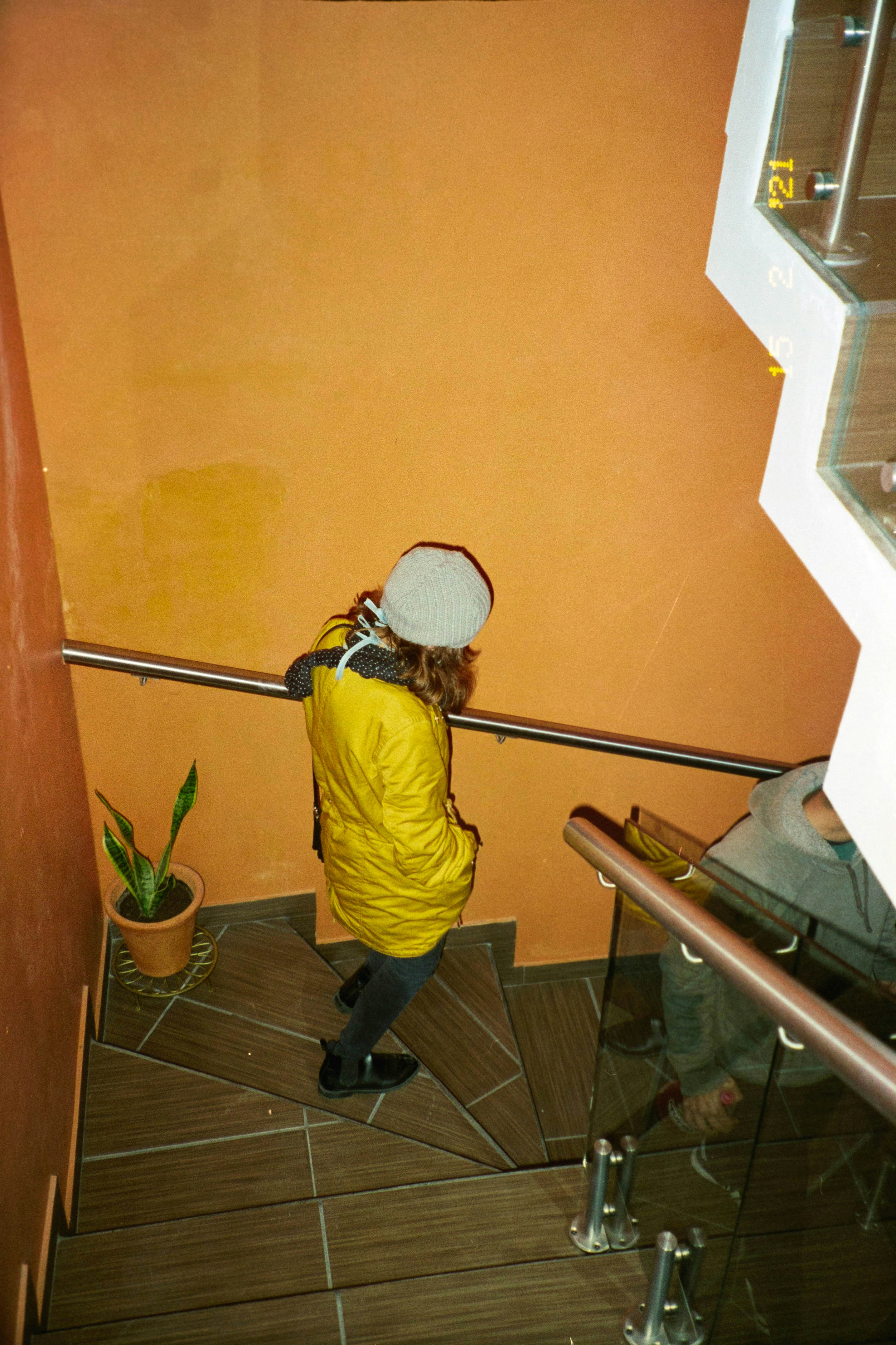 A person testing paint samples on a small wall section