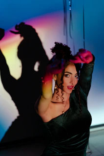A vibrant scene of an extroverted woman in a bold, conceptual dress with sharp shadows and artistic lighting