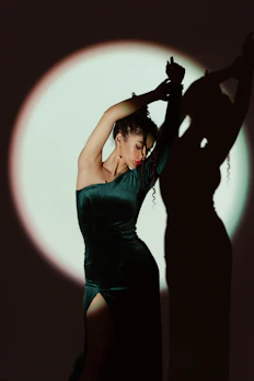 A deep plum velvet dress with a classic cut, shown against a light neutral backdrop.