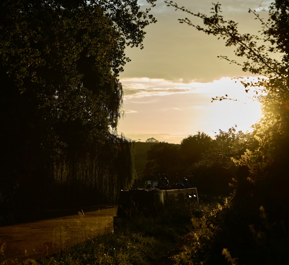 the sun is setting in the distance over the trees