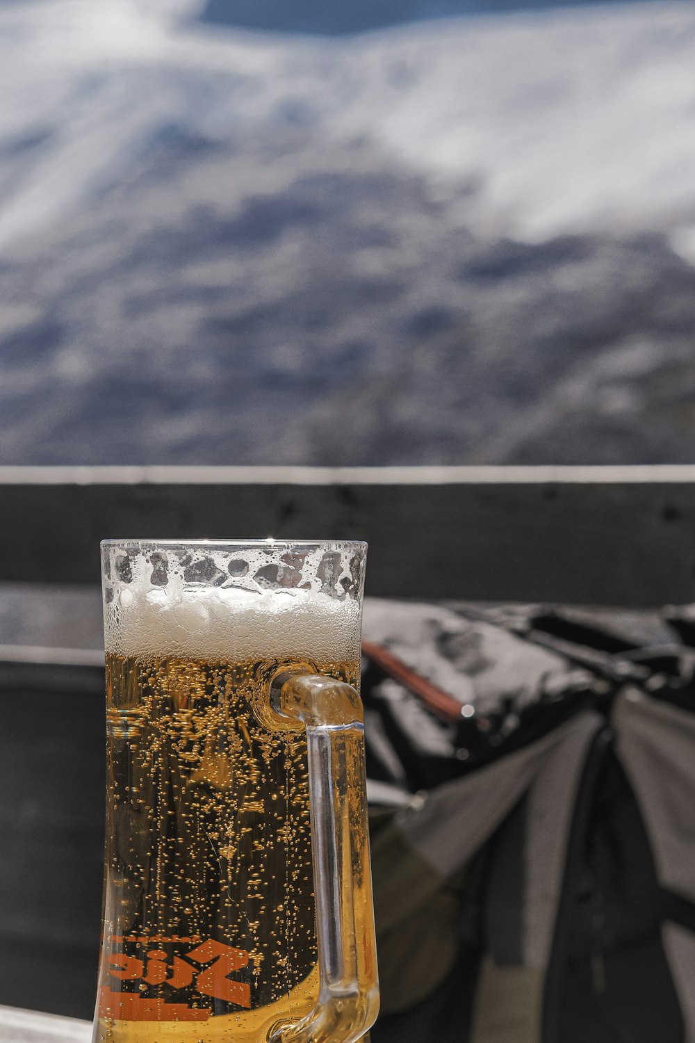 a glass of beer sitting on top of a table