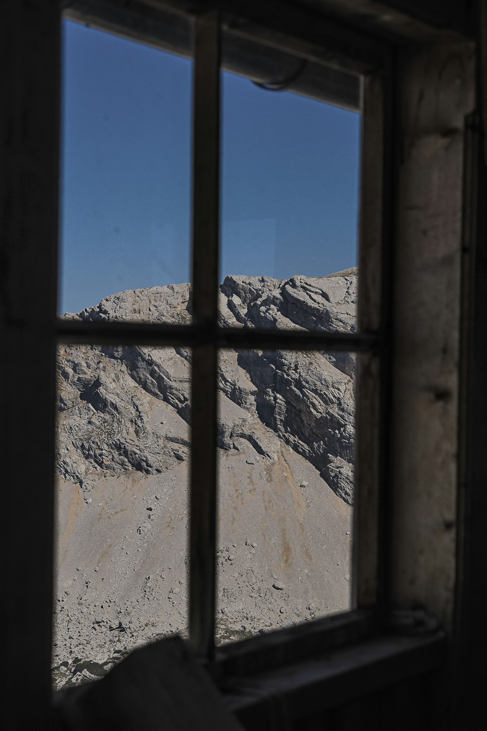 a window with a view of a mountain