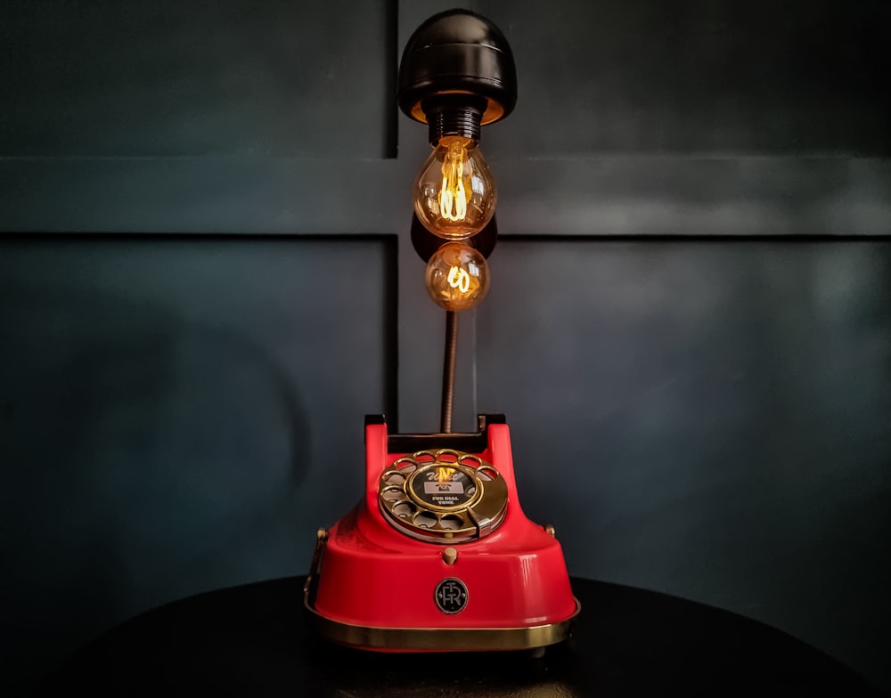 a red telephone sitting on top of a table