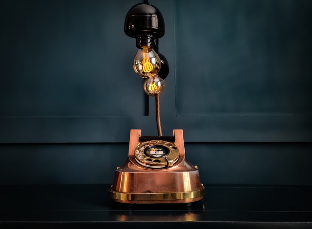 an old fashioned phone sitting on top of a table